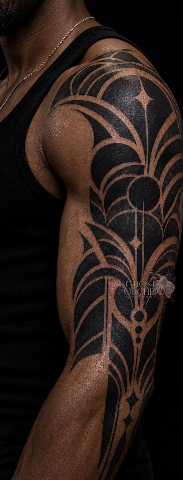 Blackwork half sleeve in solid black, built from arcing petal shapes and negative-space linework